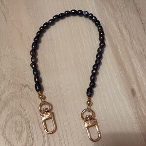 The CAEP black pearls phone wristlet